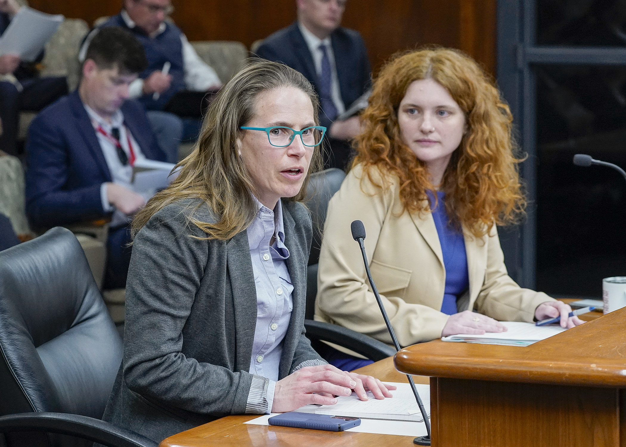 Kate Bailey, chief policy officer at The Association of Plastic Recyclers, testifies Feb. 21 in support of a bill sponsored by Rep. Sydney Jordan, right, that would establish a beverage container recycling refunds program. (Photo by Andrew VonBank)
